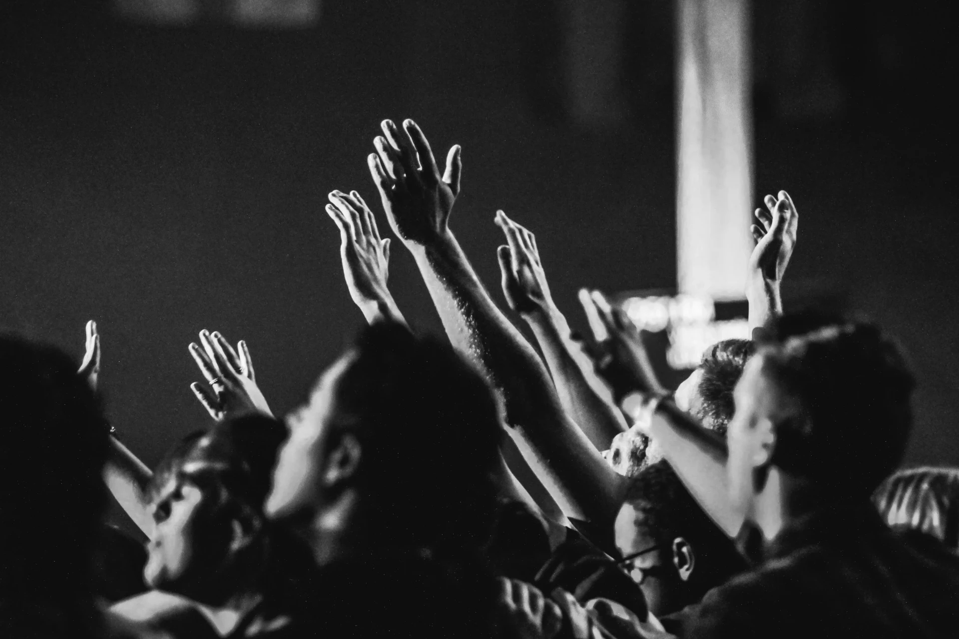 People with hands raised in worship at New Life Community Church in Inwood, West Virginia